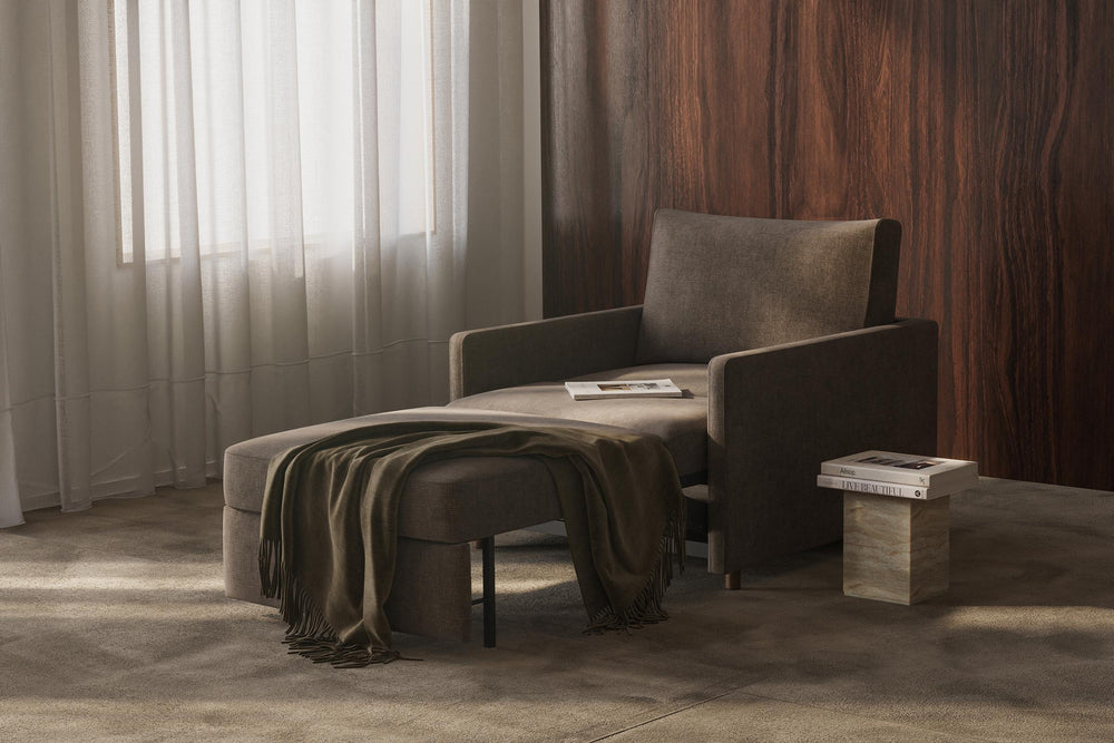 Neah Sleeper Chair by Innovation Living in dark grey with the seat pulled out as a lounger by sheer curtains