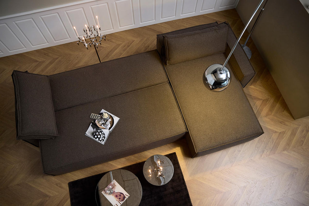 Newilla Sleeper Chaise Sectional by Innovation Living in brown with chaise, seen from above on a herringbone floor with an arc lamp