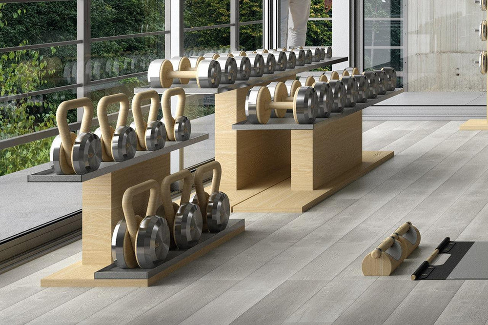 PENT Fitness kettlebells and dumbbells displayed on wood stands