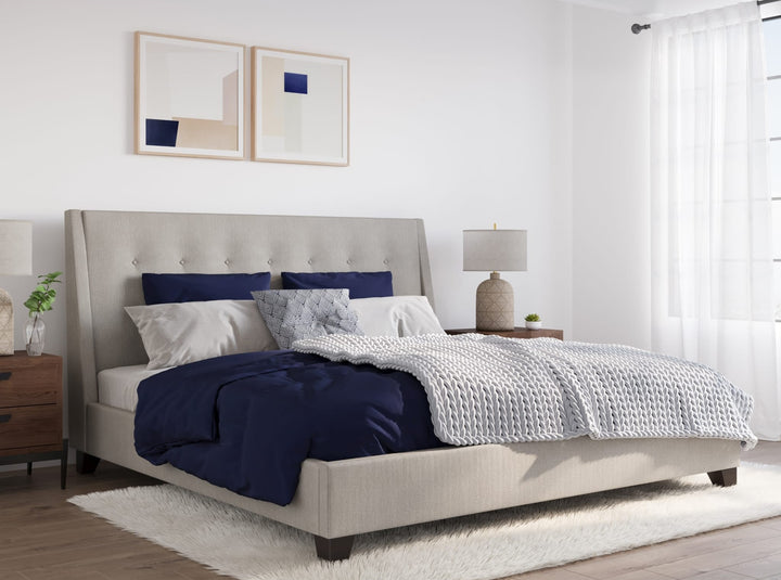 Madera Upholstered Platform Bed in Putty styled in a bedroom