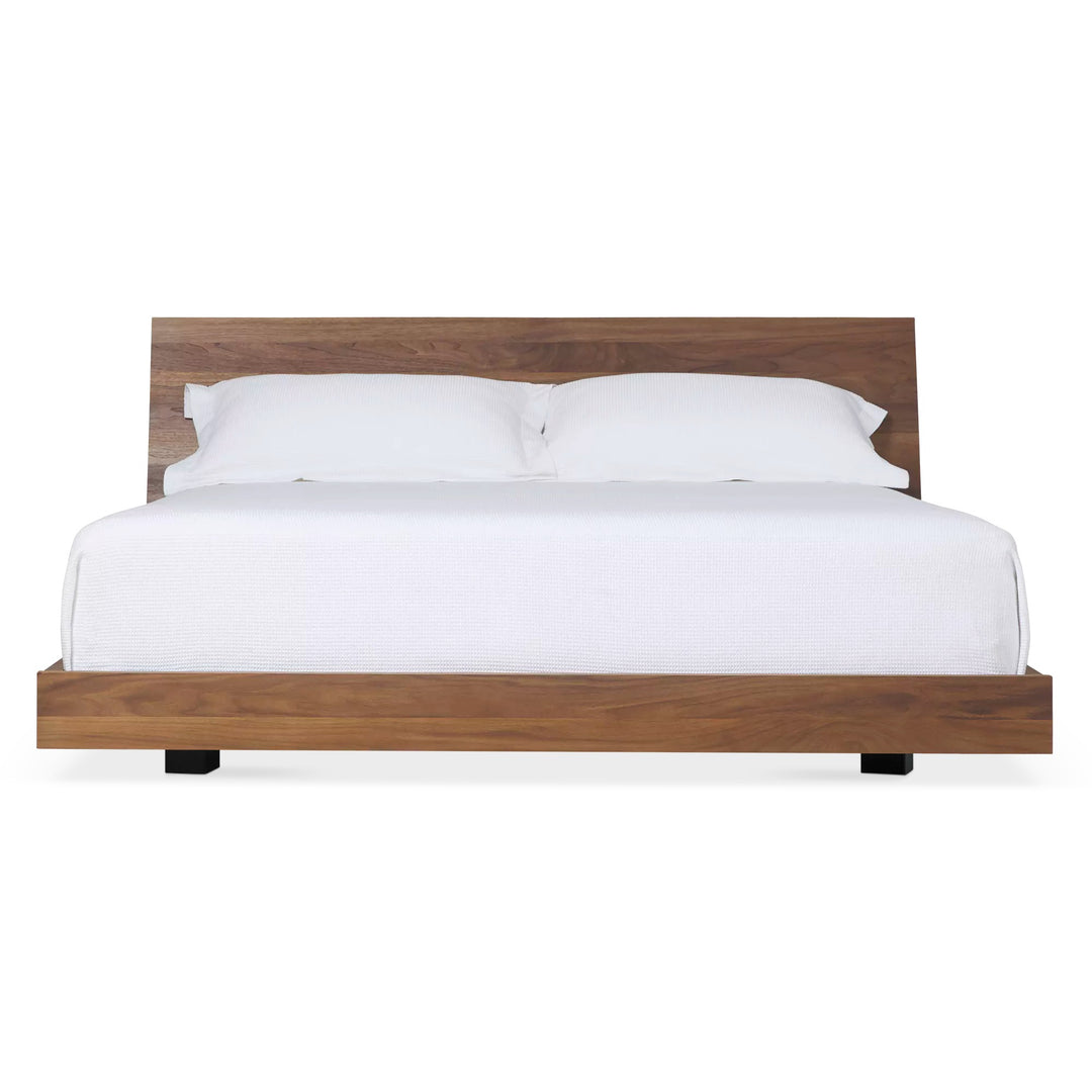 Mira Bed — front view, walnut