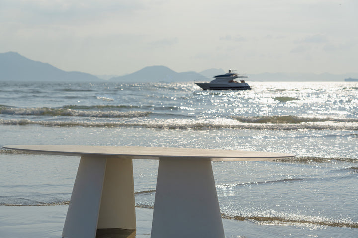 Mobital Tumuli oval outdoor dining table in Tapioca, alternate lifestyle view