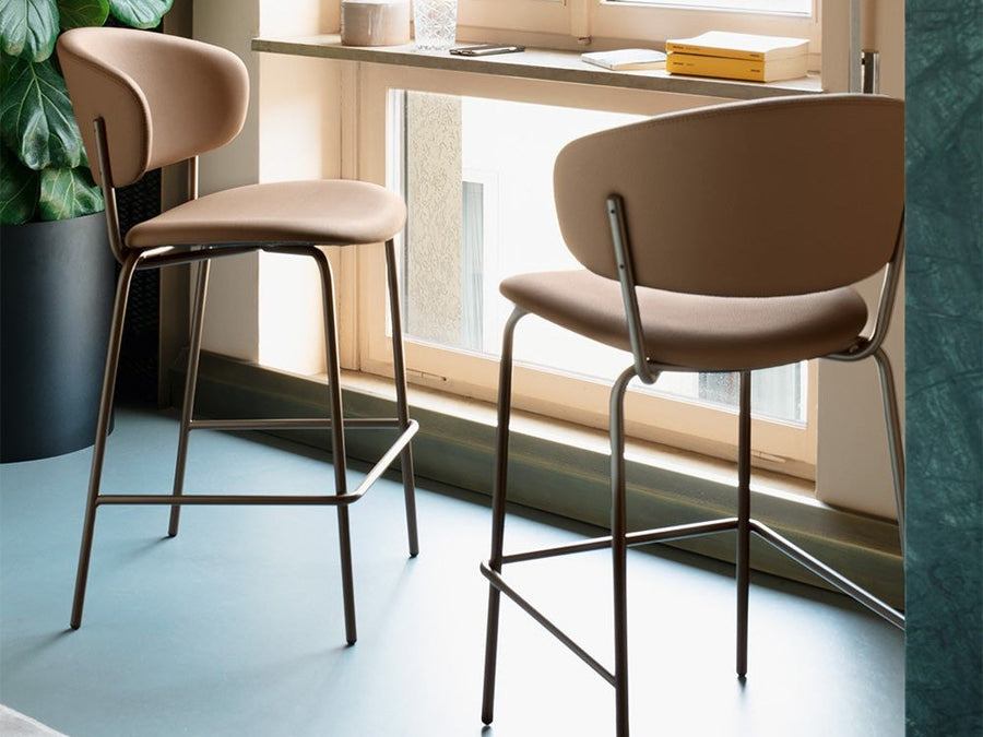 Connubia Desy upholstered counter stools beside a sunny window