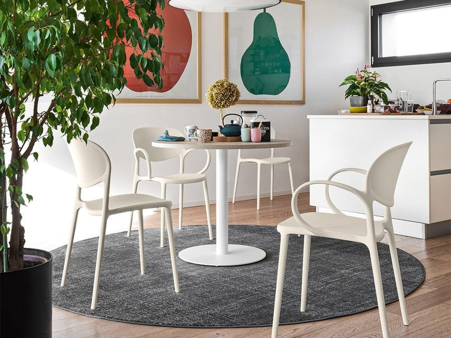 Connubia Abby dining chairs around a round white pedestal table