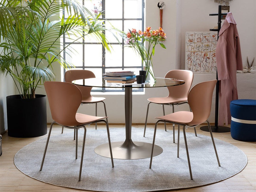 Connubia Planet round dining table with upholstered chairs on a round rug