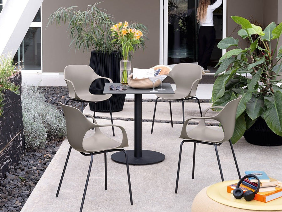 Connubia Ops! outdoor dining armchairs around a round table on a terrace