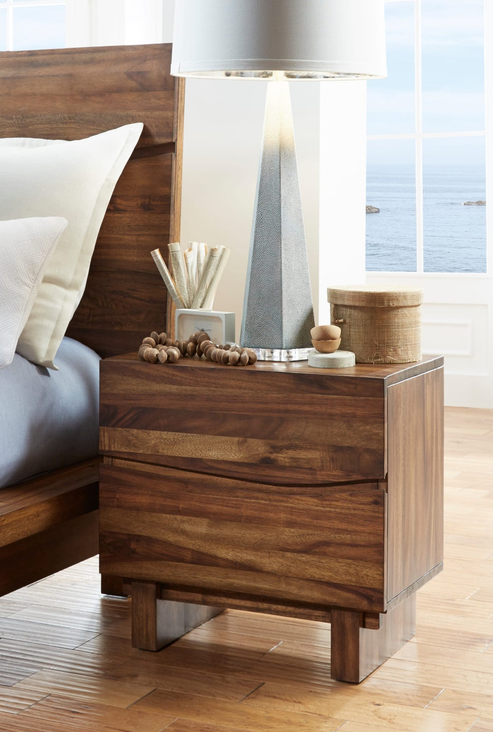 Ocean Two Drawer Solid Wood Nightstand in Natural Sengon — in a bedroom setting