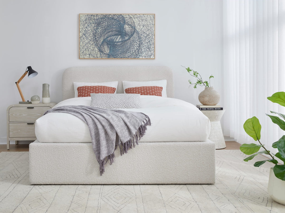 Off-White Upholstered Platform Bed in Ricotta Boucle styled in a bedroom
