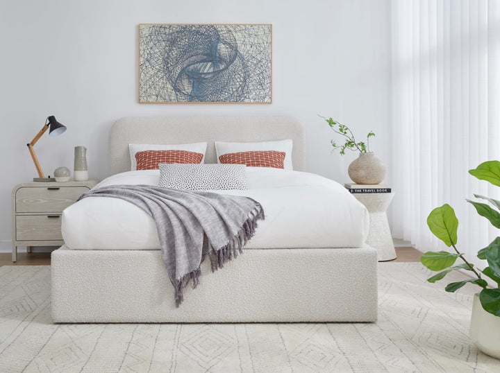 Off-White Upholstered Platform Bed in Ricotta Boucle styled in a bedroom