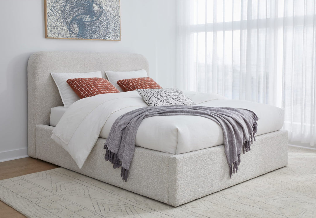 Off-White Upholstered Platform Bed in Ricotta Boucle styled in a bedroom