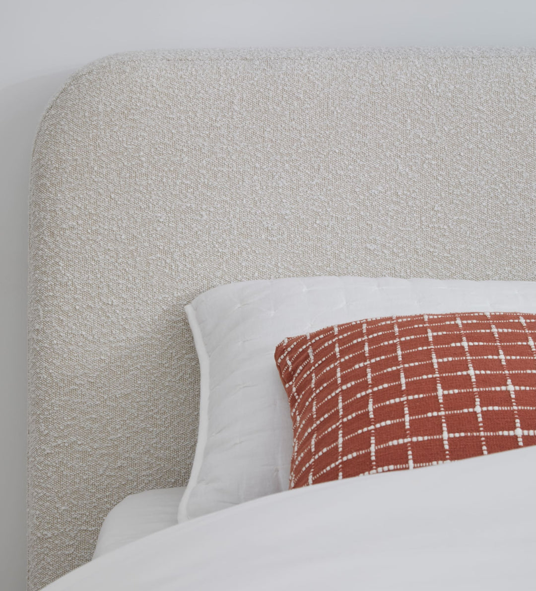 Off-White Upholstered Platform Bed in Ricotta Boucle — close-up of the boucle headboard