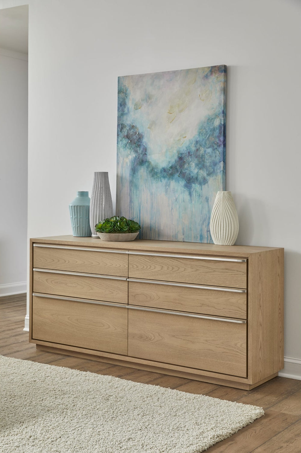 One Coastal Six Drawer Dresser in Bisque — styled in a room