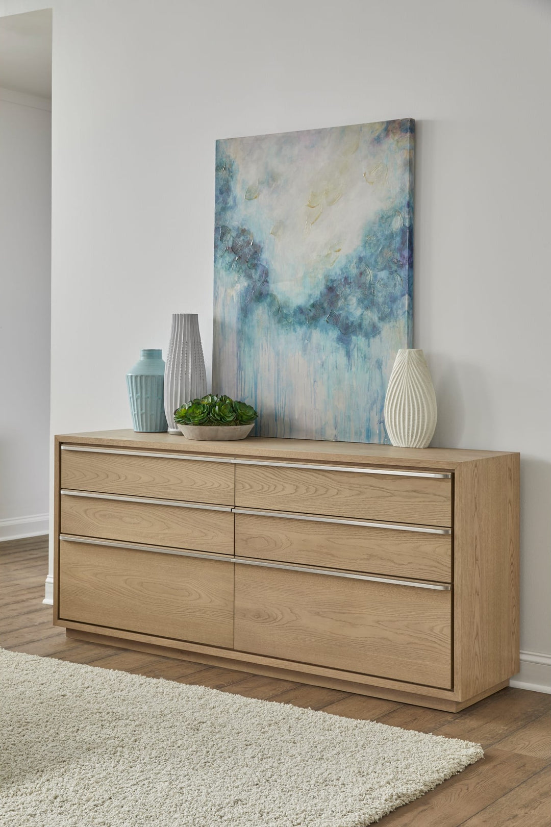 One Coastal Six Drawer Dresser in Bisque — styled in a room