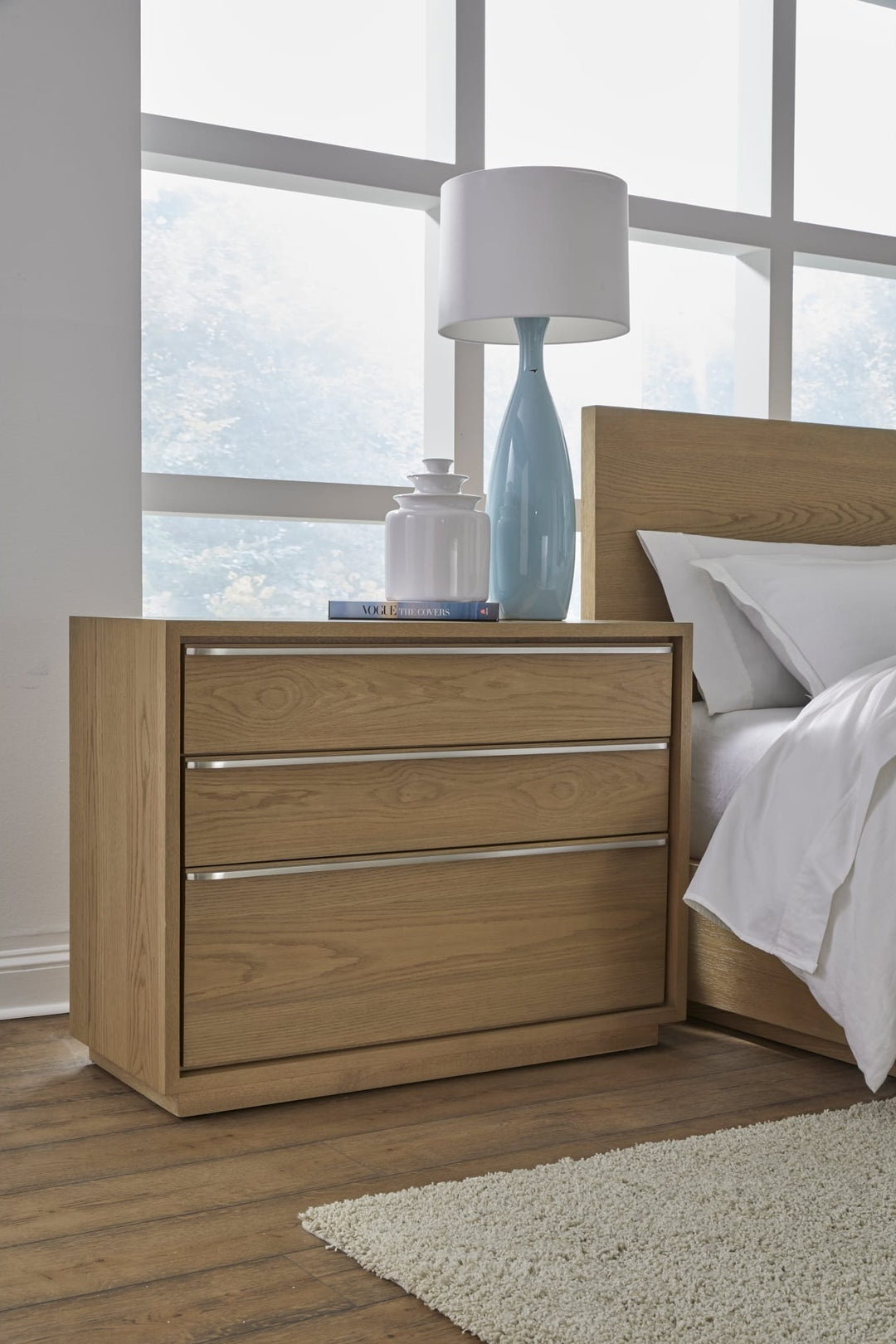 One Coastal Three Drawer USB-Charging Nightstand in Bisque — in a bedroom setting