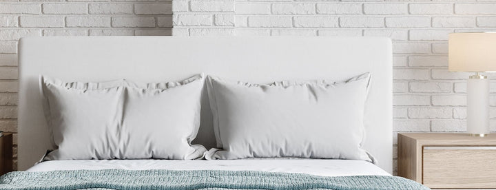 One Upholstered Footboard Storage Bed in Pearl styled in a bedroom