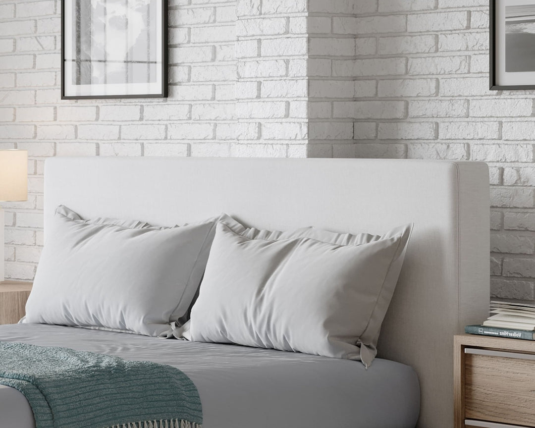 One Upholstered Platform Bed in Pearl styled in a bedroom