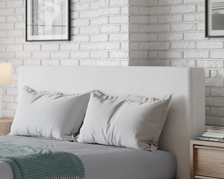 One Upholstered Platform Bed in Pearl styled in a bedroom