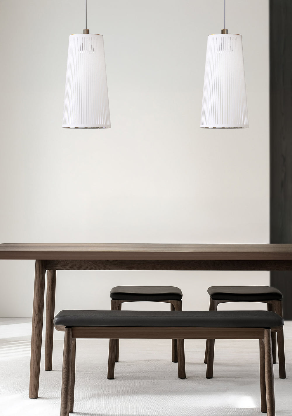 Solis Suspension Pendant by Pablo Designs over a dining table with benches