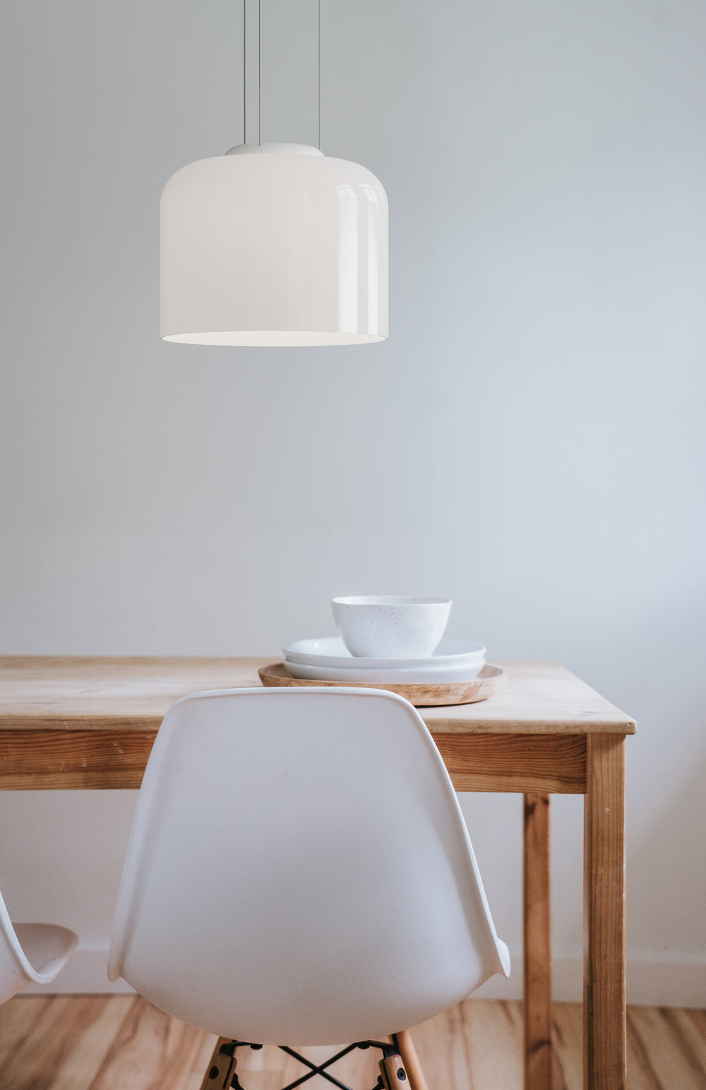 Totem Down Light by Pablo Designs over an oak dining table