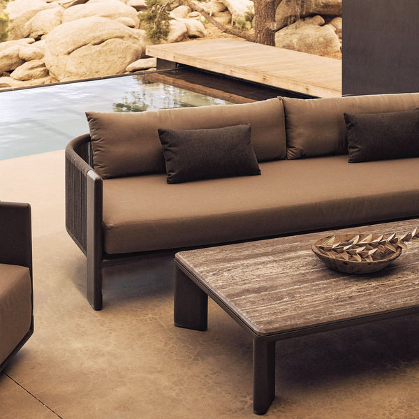 Harbour Outdoor cushioned sofa and wood coffee table beside a pool