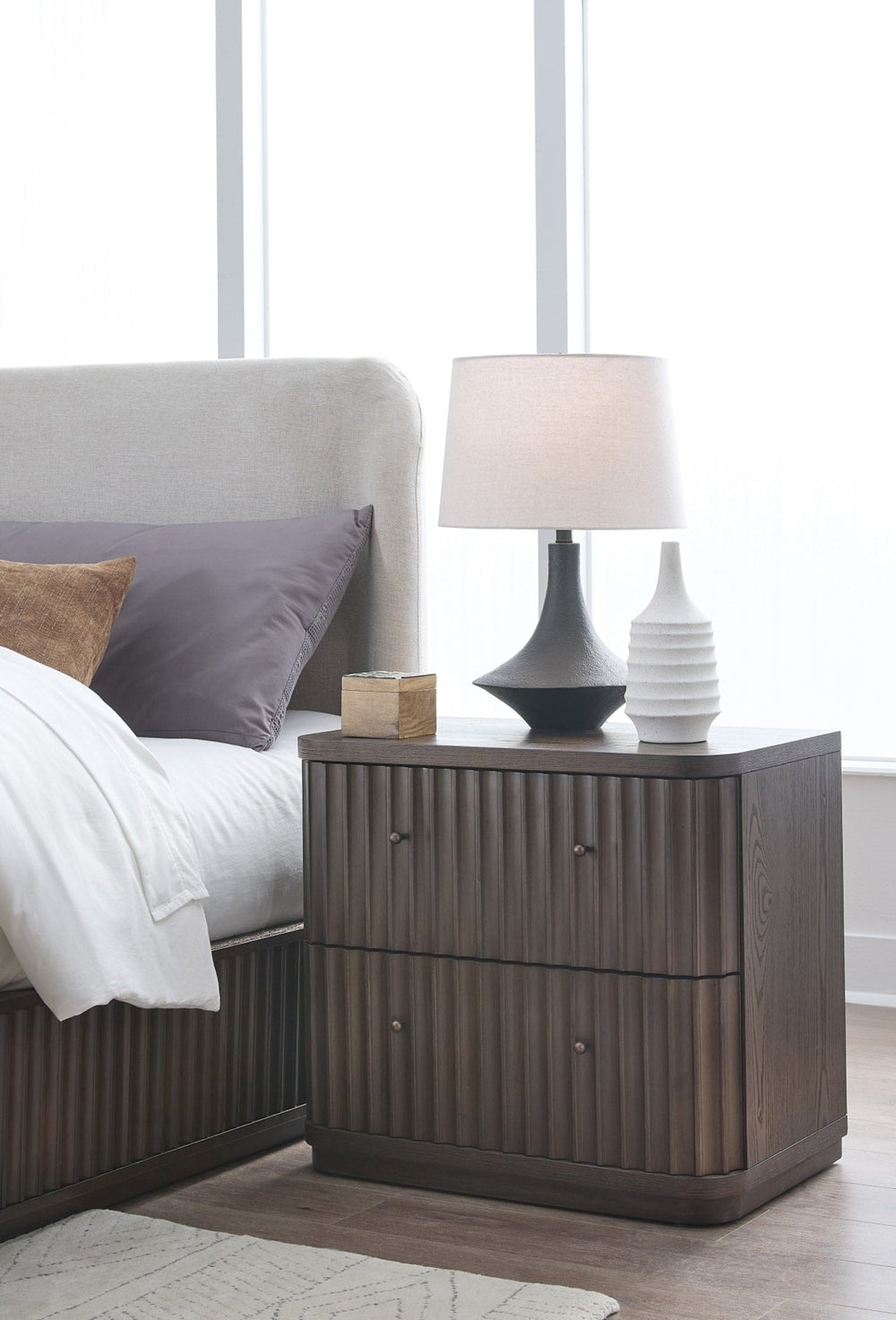 Penny Fluted Nightstand in Chocolate Mousse — in a bedroom setting