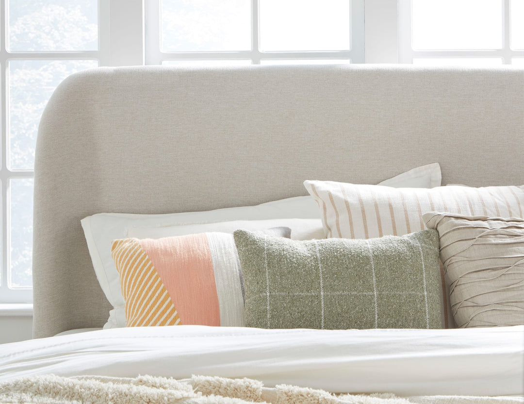 Penny Upholstered Platform Bed in Buff Cream styled in a bedroom