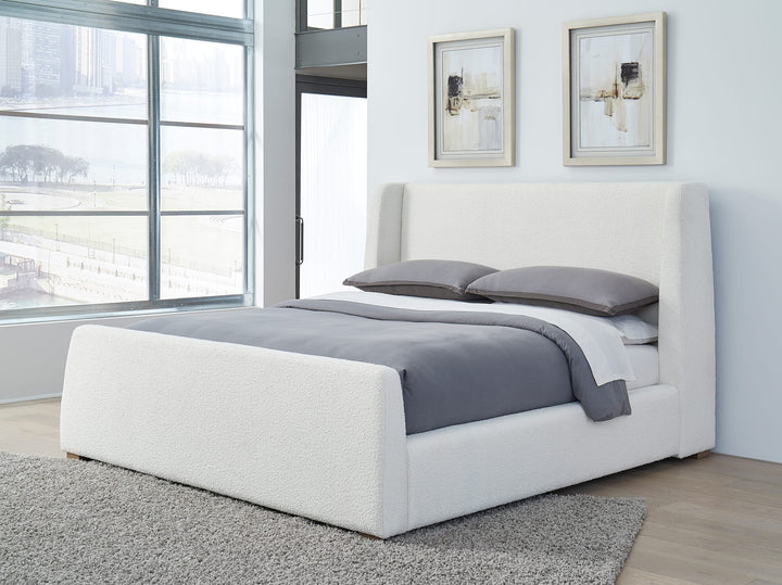 Presley Upholstered Wingback Platform Bed in Cottage Cheese Boucle styled in a bedroom