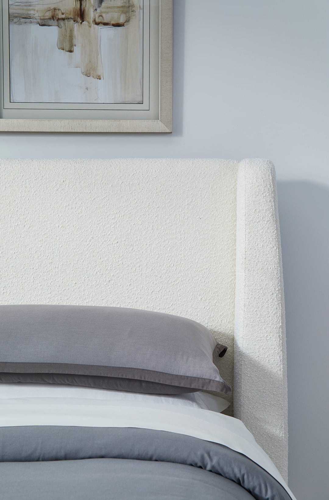 Presley Upholstered Wingback Platform Bed in Cottage Cheese Boucle styled in a bedroom