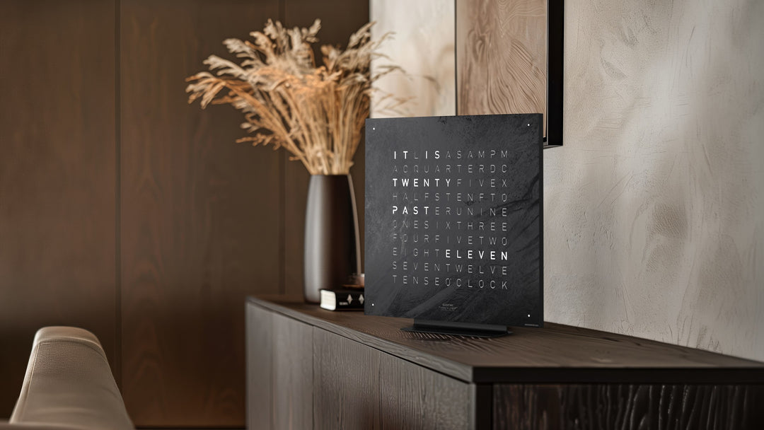 QLOCKTWO EARTH 45 Metamorphite on the black stand on a sideboard
