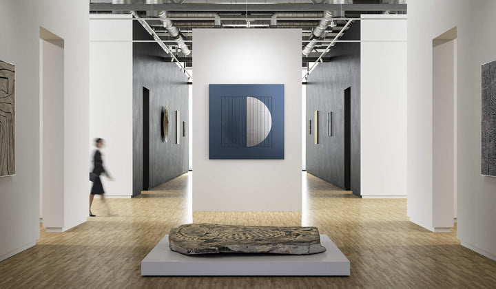 QLOCKTWO MOON 180 Midnight Platinum in a gallery hall