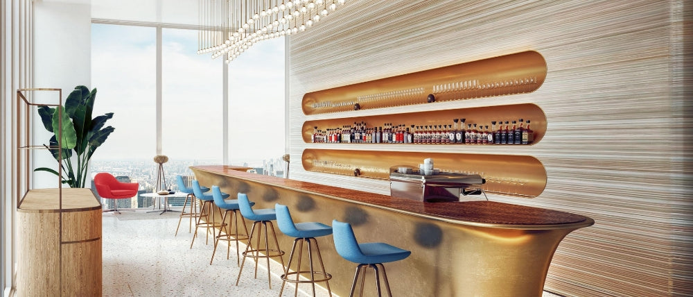Soho Concept blue upholstered stools in a sunlit bar interior
