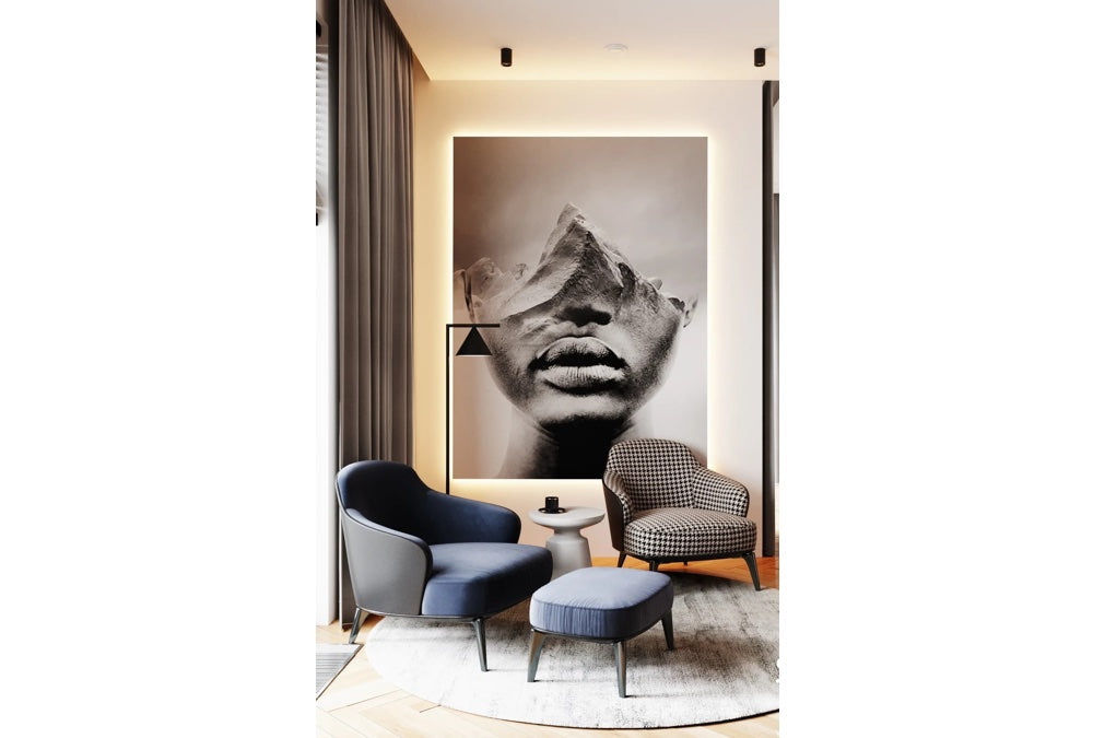 Lounge chairs and an ottoman in an art-filled sitting area