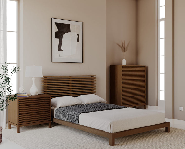 Tanner Five Drawer Chest in Roux — in a bedroom setting