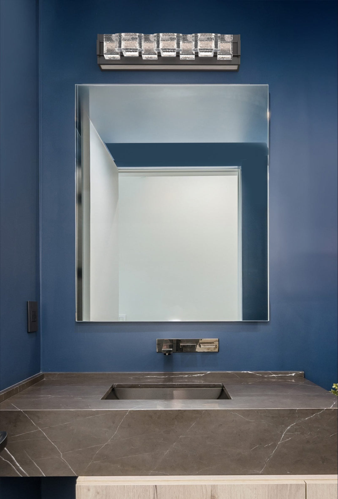 Tessera Vanity Sconce by Hammerton Studio in a styled interior