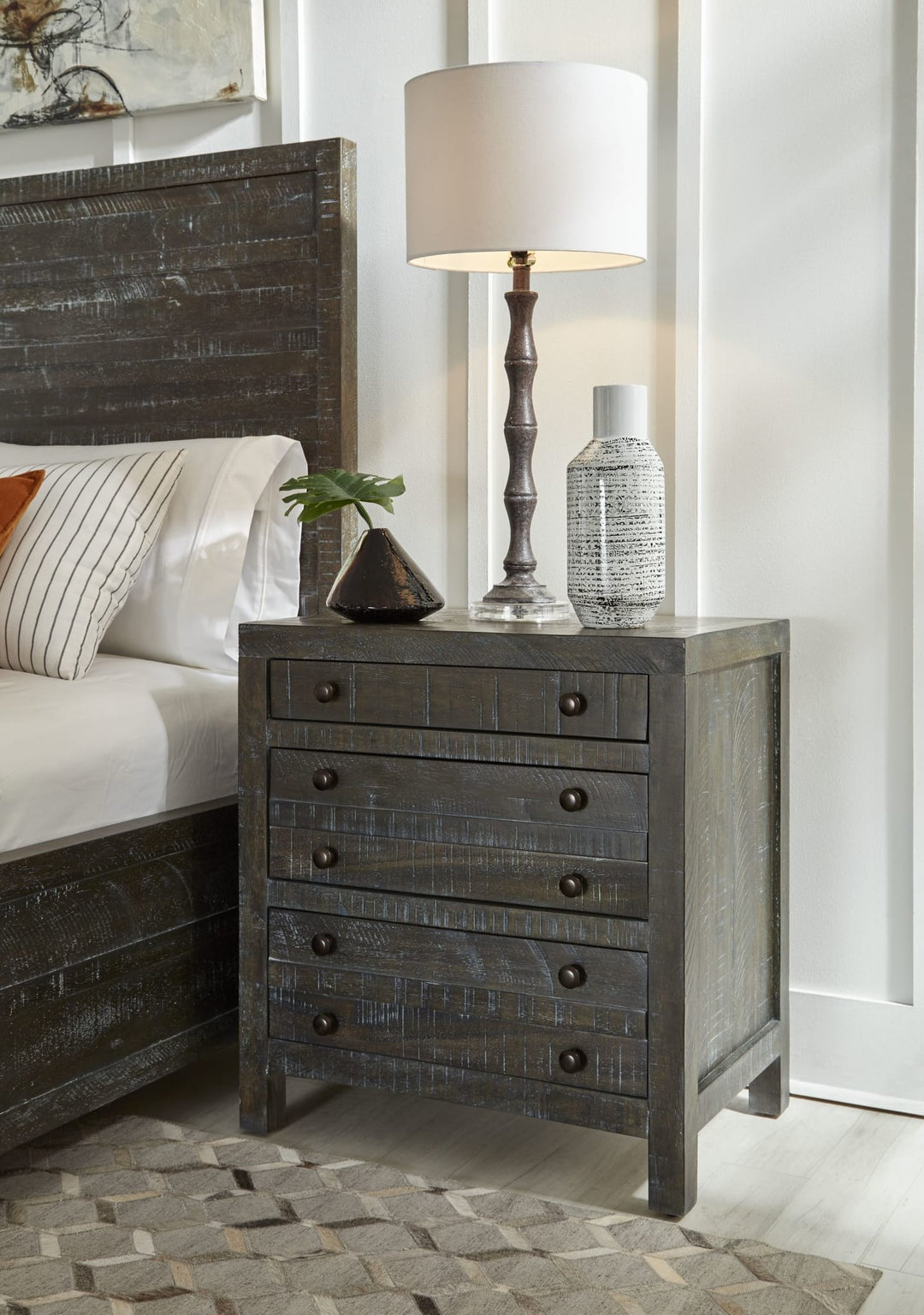 Townsend Three Drawer Solid Wood Nightstand in Gunmetal — in a bedroom setting