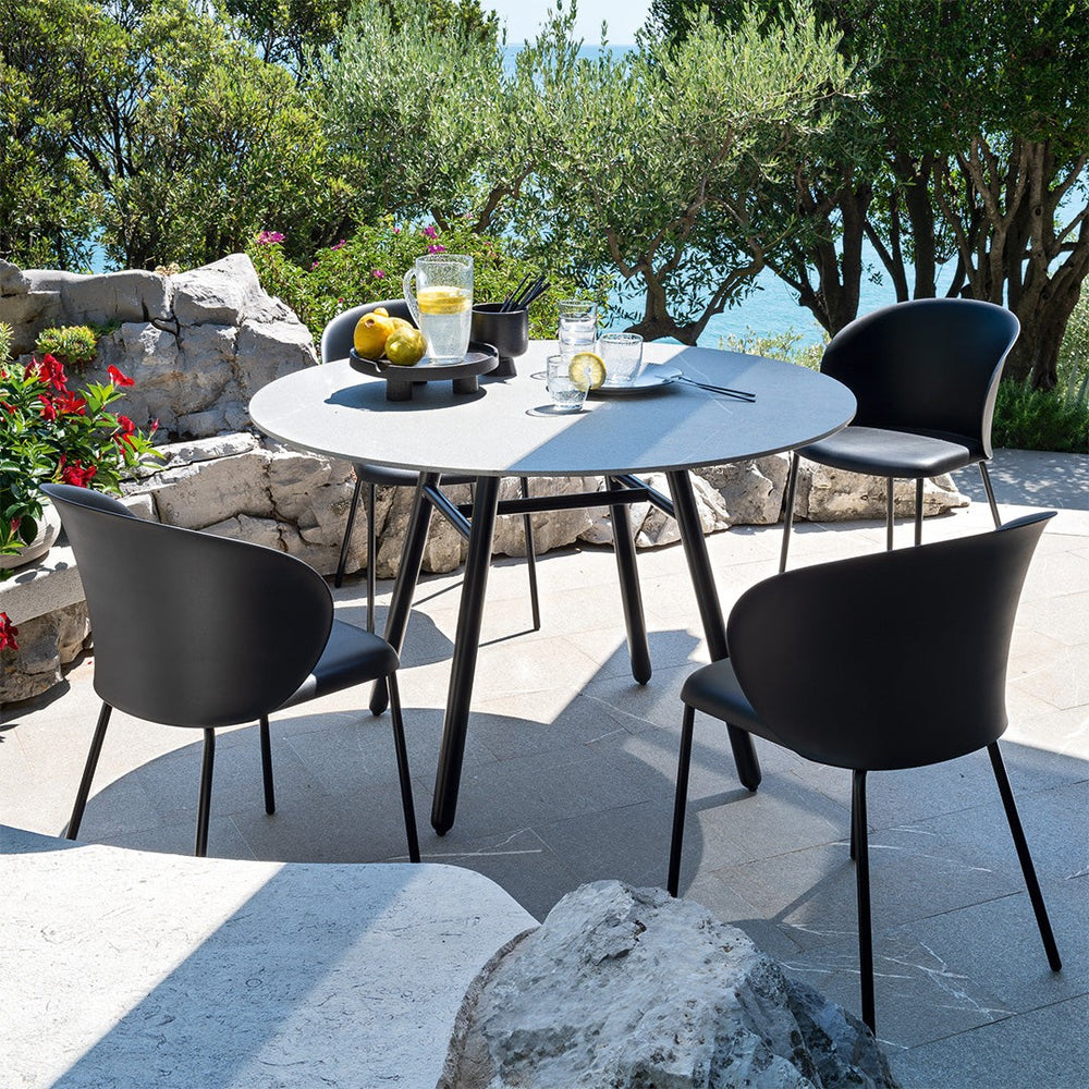Tuka Outdoor Dining Armchair by Connubia in a styled interior