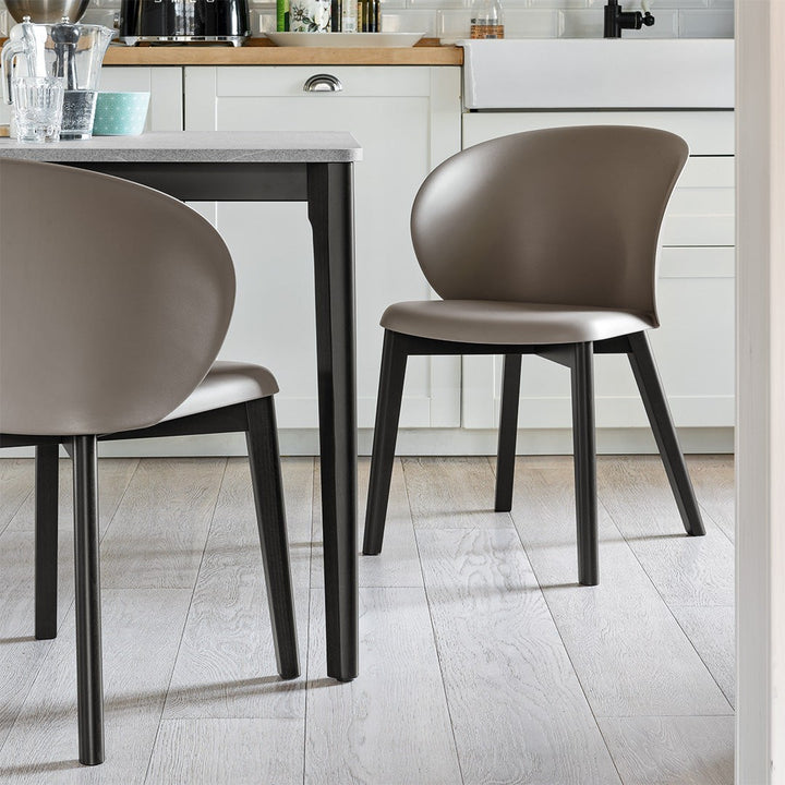 Tuka Wood Dining Armchair by Connubia in a styled interior