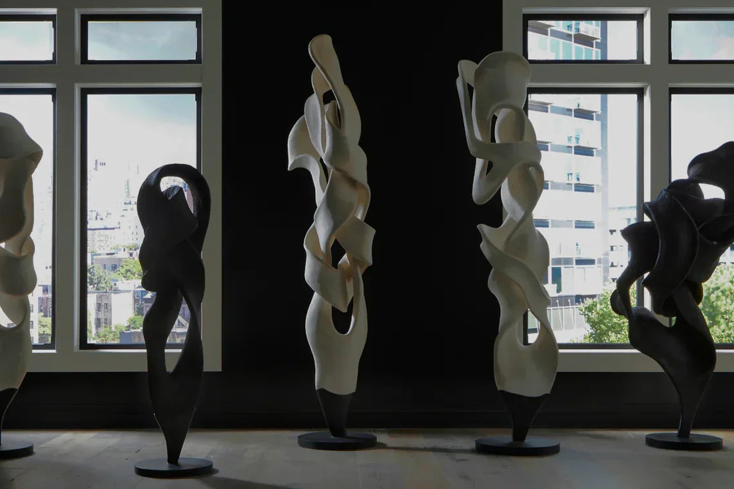 Abstract floor sculptures in a modern room with city windows at Modern Studio