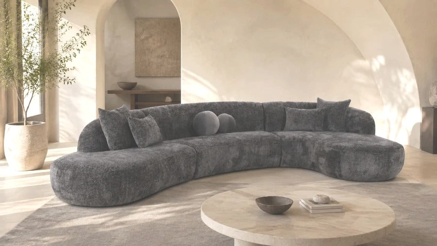 Curved charcoal Mobital sectional living room with round stone coffee table